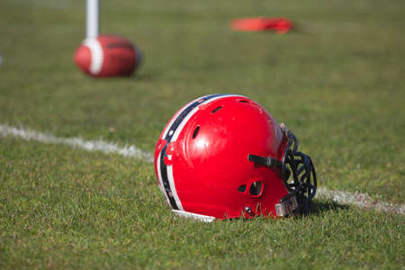 American football helmet on the playing field Stock Photo