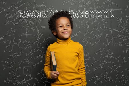 Clever child on chalkboard background back to school